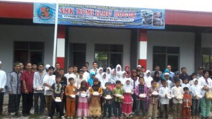 Pengurus SMK Bumi Ilmu bersama anak yatim pada acara santunan sekaligus pembukaan pendaftaran (dok. KM)