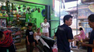 Kenlis (berbaju putih) sedang memantau usaha bengkel dan toko perlengkapan motor nya (dok. KM)