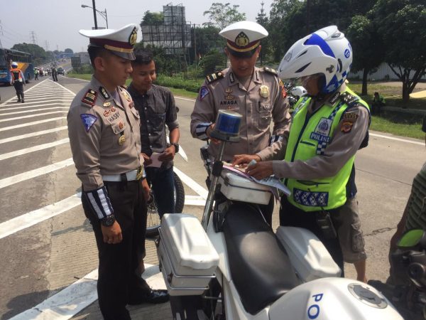 Polisi menilang pengemudi truk saat razia, Minggu 13/8 (dok. KM)