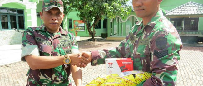 Letkol Kav Fadjar Wahyudi Broto saat membagikan puluhan spare part sepeda motor berupa ban dan baterai serta suku cadang lainnya kepada Babinsa jajarannya di halaman Makodim setempat, Kamis 25/1 (dok. Ist/Raz/KM)