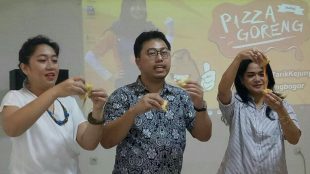 Pengelola Pizza Goreng memperlihatkan cara makan Pizza Goreng saat temu bersama wartawan di outlet barunya di Bogor, Sabtu 31/3 (dok. KM)
