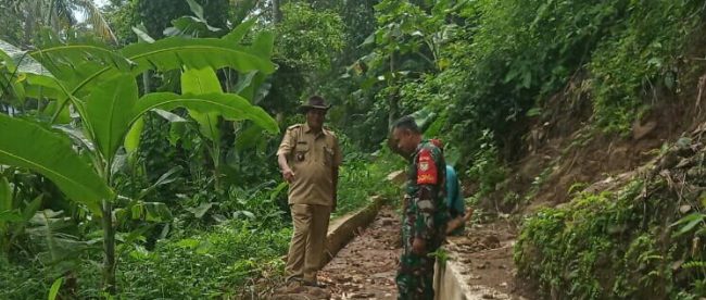 Kades Cijambe Didin S. bersama Babinsa di lokasi saluran air Cikukulu yang mengalami kerusakan (dok. KM)