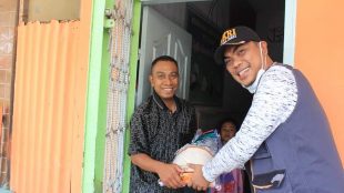 Ketua GM Pekat-IB Khairul Anhar Harahap membagikan sembako kepada salah satu warga Kota Kisaran, Asahan, Senin 6/4/2020 (dok. KM)